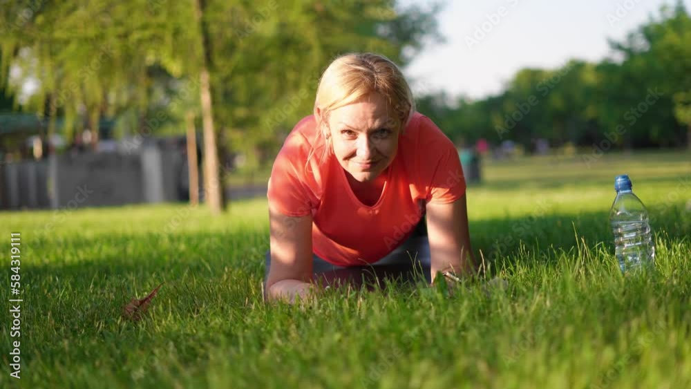 Mature woman doing sports outdoors on a sunny summer day in park Mature woman doing sports outdoors on a sunny summer day in park