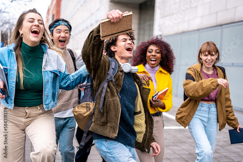 young students celebrate on the street the end of school exams, expressions of happiness and satisfaction, multiracial group of laughing college students photo