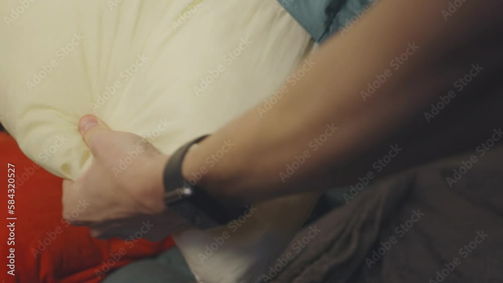 Man Changing Bed Linens Removing Pillowcase. Close Up Man Changing Bed Linens Removing Pillowcase. Close Up