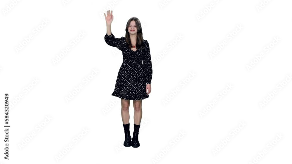 Smiling young woman in dress and boots standing and waving hand greeting, Full HD footage with alpha transparency channel isolated on white background Smiling young woman in dress and boots standing and waving hand greeting, Full HD footage with alpha transparency channel isolated on white background