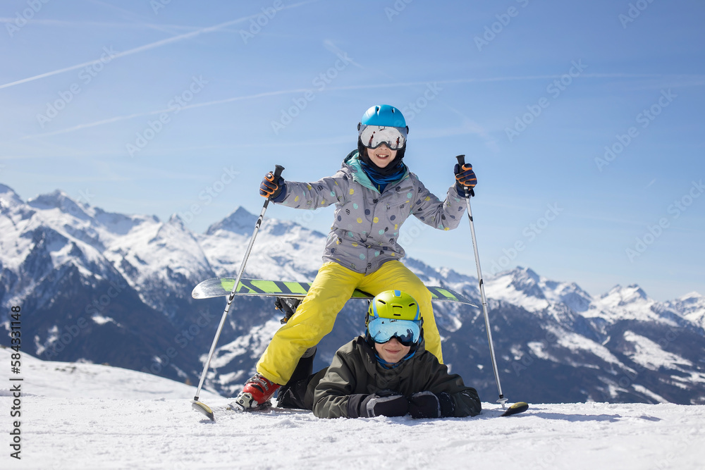 Happy family, enjoying ski holiday with children, sunny beautiful weather Happy family, enjoying ski holiday with children, sunny beautiful weather
