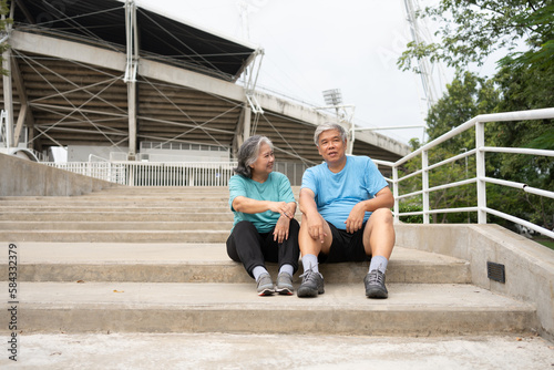 Happy and smile couples elderly asian sitting on stairs for rest after workout  jogging on morning  senior exercise outdoor for good healthy. Concept of healthcare and active lifestyle for healthy