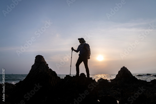 Tourists with backpacks hike on rocky top mountain trekking is adventure sport for Traveller who love hiker on summer holidays trekking and activity.