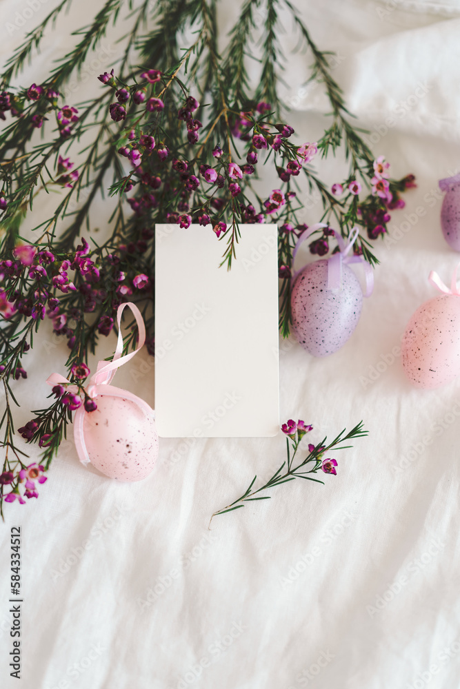 Easter eggs with flowers on white linen fabric. Spring and Easter concept.