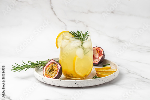 passionfruit cocktail on a dark background. Tropical drink for summer party. Alcoholic cocktail with fresh passion fruit
