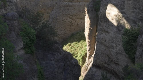 Ronda, a beautiful view of Ronda’s El Tajo Canyon on a sunny summer day. Ronda, a famous UNESCO heritage city in Malaga Province, Andalusia, Spain photo