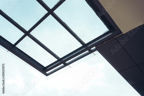 Modern garage upgrade: showcasing a glass canopy roof model with a clear sky setting during daytime