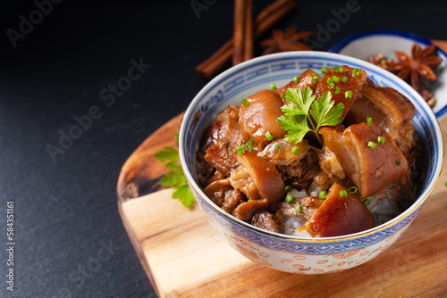 Food concept Spot focus Homemade Asian 5 spice  braised pork and rice on black background with copy space