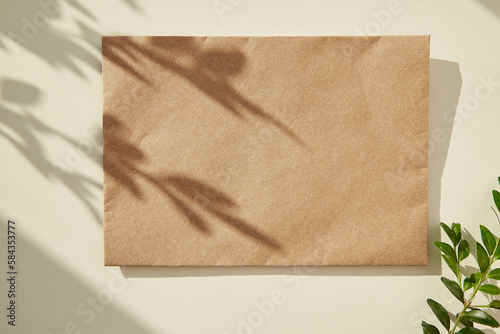 Mock up of craft envelope under shadow. Copy space