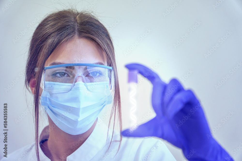 DNA structure anlysing. Young scientist or doctor holding DNA hologram. Innovation in medicine. Medicine of the future. DNA structure anlysing. Young scientist or doctor holding DNA hologram. Innovation in medicine. Medicine of the future.