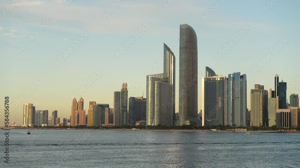 Sunset over Abu Dhabi skyline. 4K video with modern skyscraper office buildings of Abu Dhabi. United Arab Emirates, 2023. Sunset over Abu Dhabi skyline. 4K video with modern skyscraper office buildings of Abu Dhabi. United Arab Emirates, 2023.