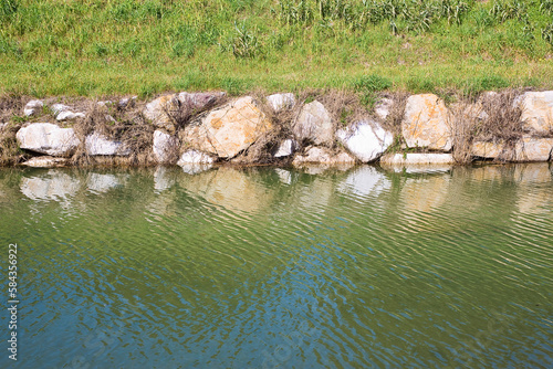 Irrigation channel with with embankments in stone blocks