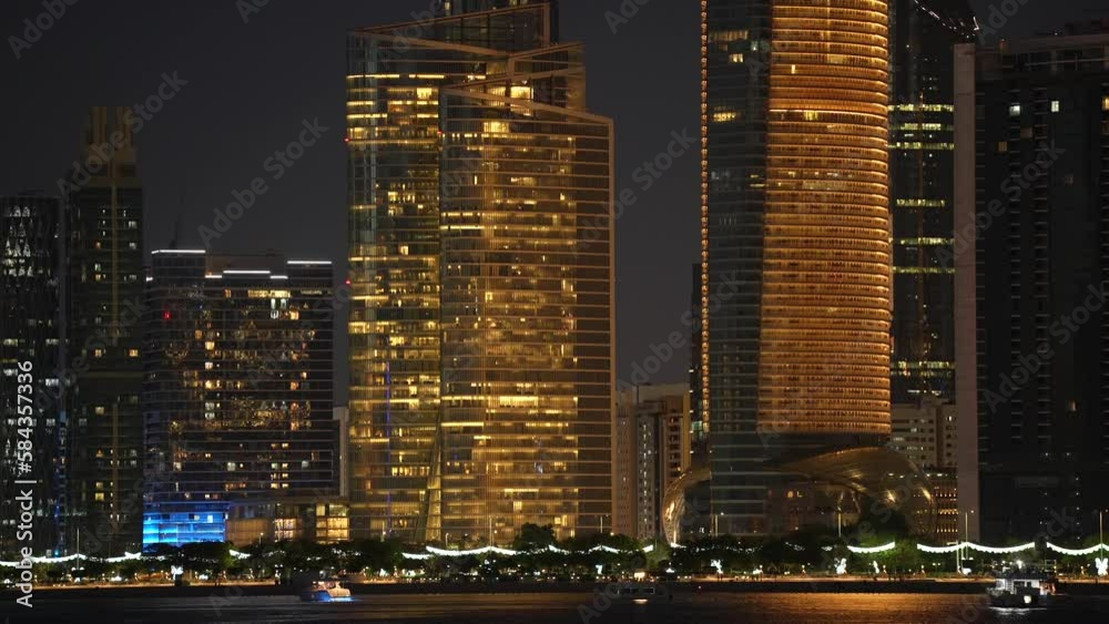 Night in Abu Dhabi. 4k video during an evening in Abu Dhabi with boats and yachts traffic in foreground. Landmarks of United Arab Emirates, 203. Night in Abu Dhabi. 4k video during an evening in Abu Dhabi with boats and yachts traffic in foreground. Landmarks of United Arab Emirates, 203.