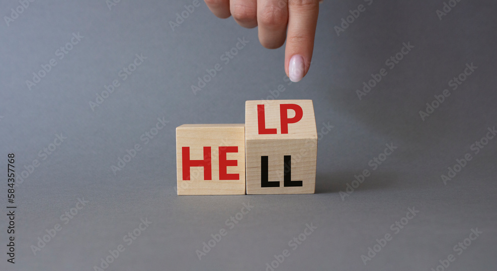 Help vs Hell symbol. Businessman hand points at turned wooden cubes with words Hell and Help. Beautiful grey background. Psychology and Help vs Hell concept. Copy space Help vs Hell symbol. Businessman hand points at turned wooden cubes with words Hell and Help. Beautiful grey background. Psychology and Help vs Hell concept. Copy space