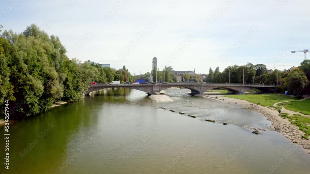Beautiful view of a bridge with cars over the river in the city of Munich, Germany Beautiful view of a bridge with cars over the river in the city of Munich, Germany