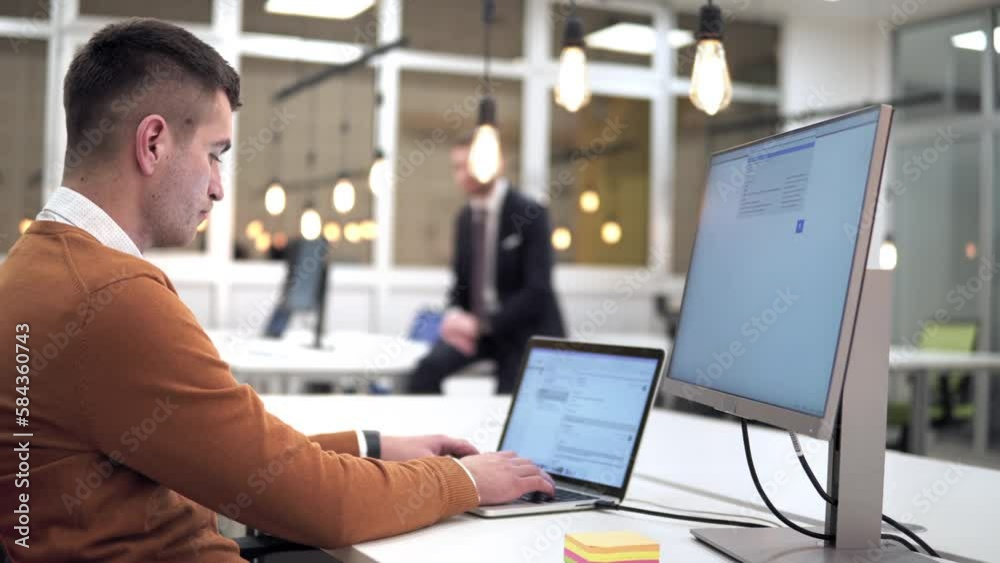 A man is feeling tired after working with his laptop. Communicate about freelancers that work a lot of hours or general remote job and computer related stress A man is feeling tired after working with his laptop. Communicate about freelancers that work a lot of hours or general remote job and computer related stress