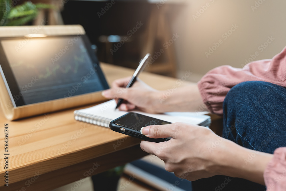 Fototapeta premium stock trade at home. Close up hand of person learning and analyzing the chart of stock market via application