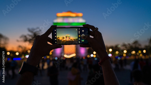 Photography Unrecognizable hand-capturing photo of The India Gate, a war memorial located at