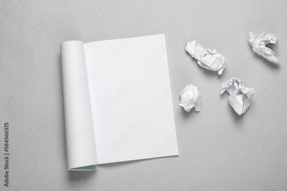 Notebook with torn crumpled sheets of paper on gray background Notebook with torn crumpled sheets of paper on gray background