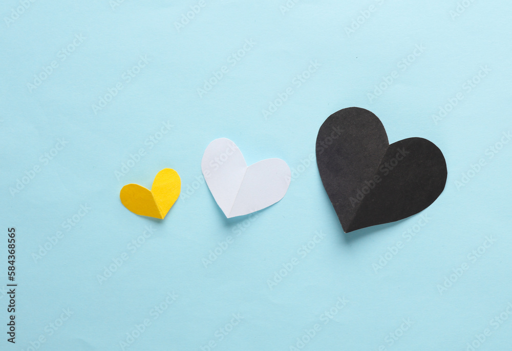 Obraz premium Paper-cut hearts on a blue background. Love concept