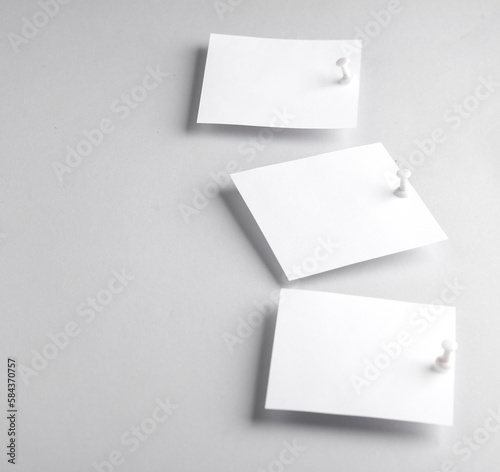 White empty square memo sheets of paper with pushpin on gray background. Template for design. © splitov27