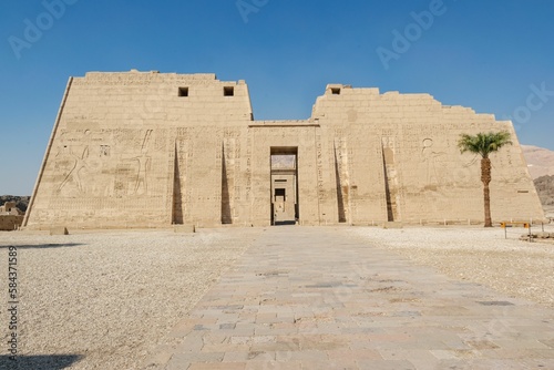 Medinet Habu archaeological locality on blue sky background in Luxor, Egypt