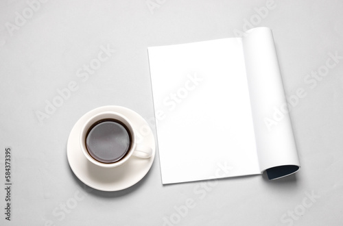 White blank magazine page mockup and coffee cup on gray background