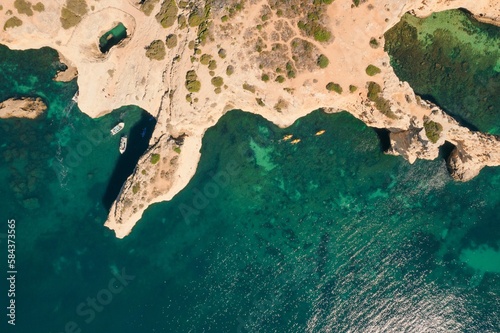 Benagil Natural Arches from above, aerial photo of Algarve costaline, Portugal © Leandro Pita/Wirestock Creators