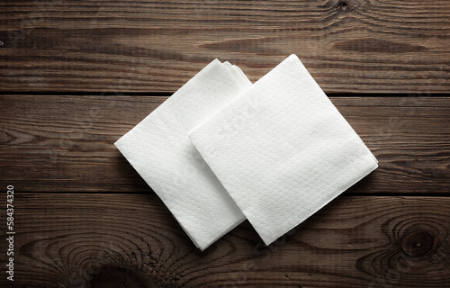 White napkins on a wooden table. Top view