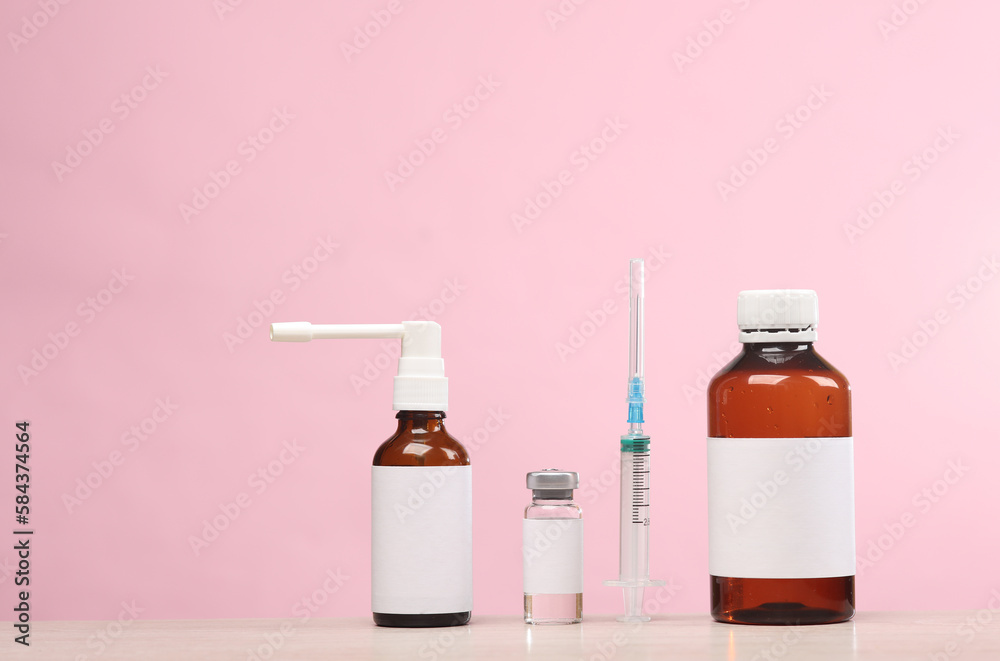 Medicines with blank labels on a pink background. Template for design ...