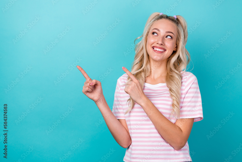 Photo of positive adorable lady beaming smile look indicate fingers empty space isolated on teal color background