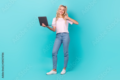 Full size photo of positive nice girl use netbook demonstrate thumb up isolated on turquoise color background