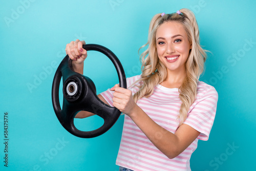Photo of adorable gorgeous lovely lady wear stylish striped clothes hold wheel enjoy own new car isolated on cyan color background