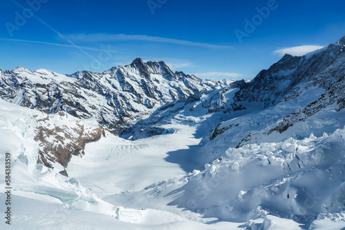 Magica view of the Alps mountains in Switzerland. View from helicopter in Swiss Alps. Mountain tops in snow. Breathtaking view of Jungfraujoch and the UNESCO World Heritage - the Aletsch Glacier