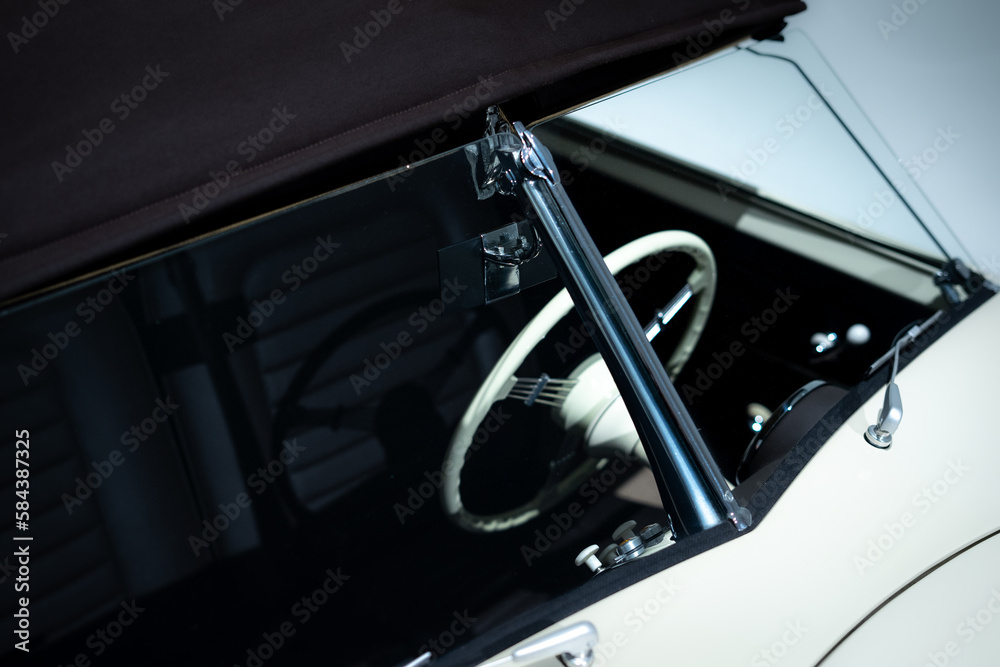 Obraz premium View of a windshield and steering wheel of a vintage car