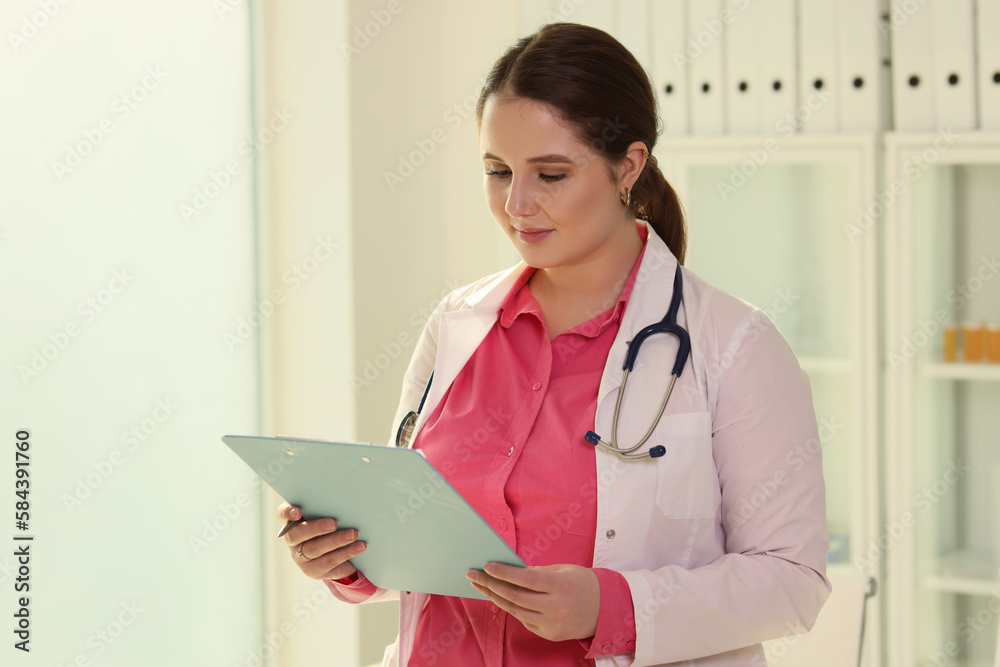 Doctor with stethoscope checks treatment plan for patient Doctor with stethoscope checks treatment plan for patient