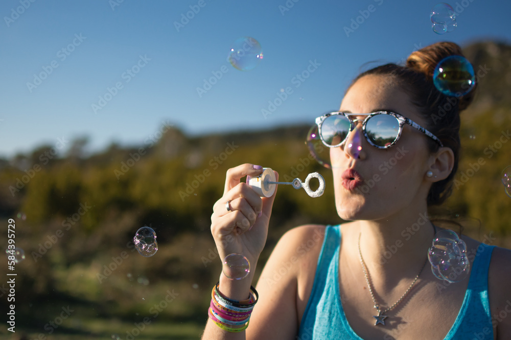 Attractive woman blowing soap bubbles Attractive woman blowing soap bubbles