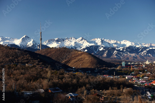 Kok-Tobe TV tower in the city of Almaty against the background of the mountain range