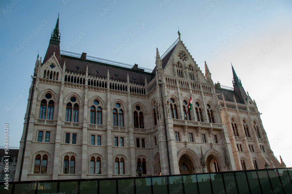A low angle of the Hungarian Parliament building at back lit by the sun in the summer in the city of Budapest