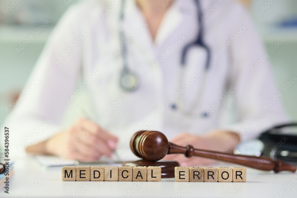 Gavel lies on wooden blocks put in words Medical Error