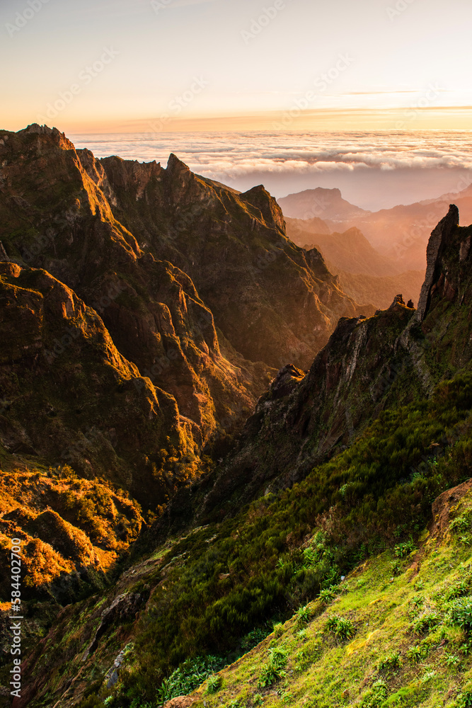Sunrise in Madeira mountains at spring. Peaks and clouds at early morning