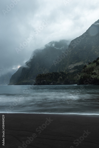 Famous volcanic black sand beach in Seixal, Madeira at dramatic cloudy weather