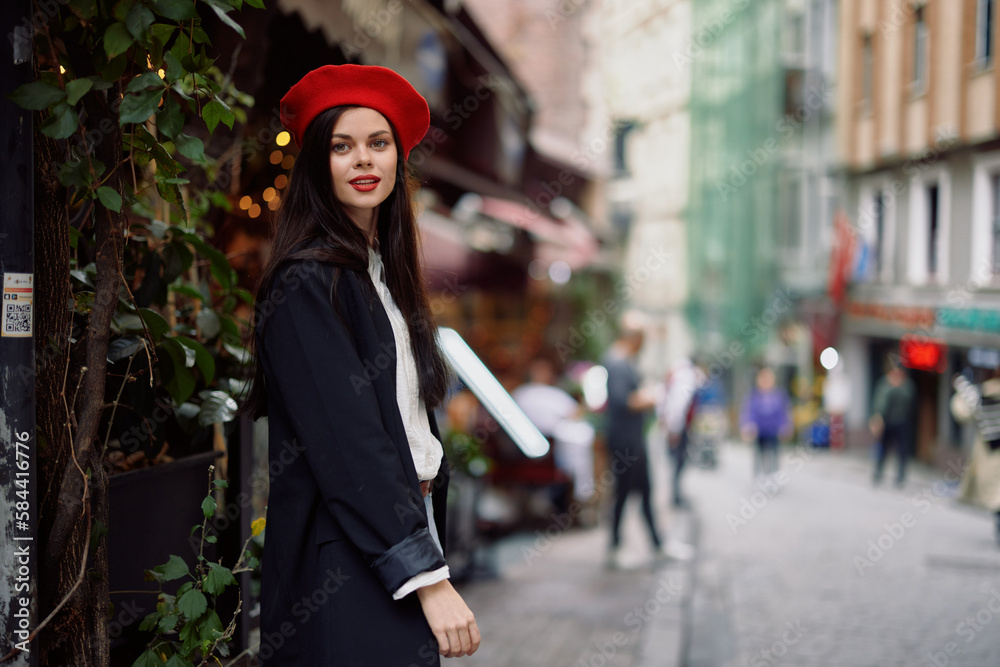 Woman smile fashion model walks on the street in the city center among the crowd in a jacket and red beret and jeans, cinematic french fashion style clothing, travel to istanbul Woman smile fashion model walks on the street in the city center among the crowd in a jacket and red beret and jeans, cinematic french fashion style clothing, travel to istanbul