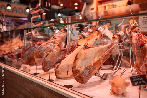 Photography Food store with jamon in La Boqueria market one of the most popular tourist landmark in the Ciudad Vieja district in Barcelona
