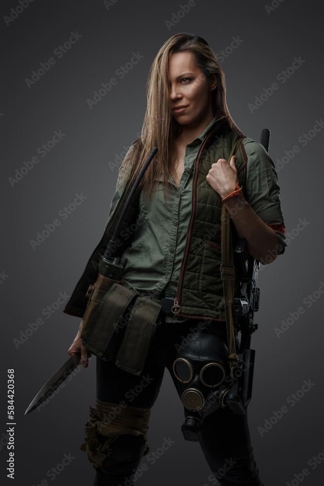 Portrait of dangerous female killer with knife in style of post apocalypse.