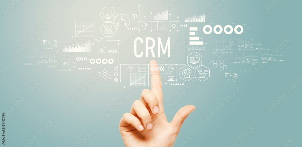CRM - Customer Relationship Management theme with hand pressing a button on a technology screen CRM - Customer Relationship Management theme with hand pressing a button on a technology screen
