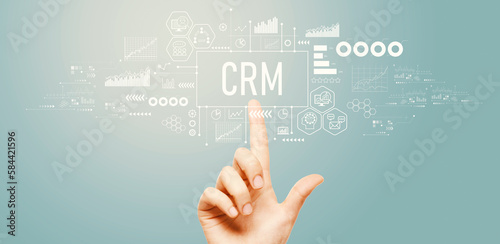 CRM - Customer Relationship Management theme with hand pressing a button on a technology screen