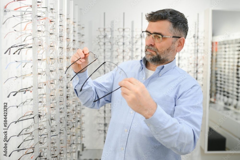 Glasses check, senior vision and elderly man at a consulting optometry clinic for wellness. Happy, smile and old face with lens, frame and eyewear choice in a store for help getting a prescription. Glasses check, senior vision and elderly man at a consulting optometry clinic for wellness. Happy, smile and old face with lens, frame and eyewear choice in a store for help getting a prescription.