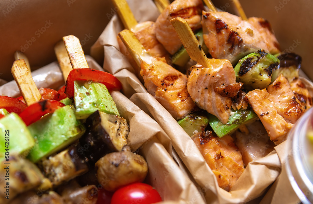 Grilled salmon fish fillet and vegetables cooked on skewers and