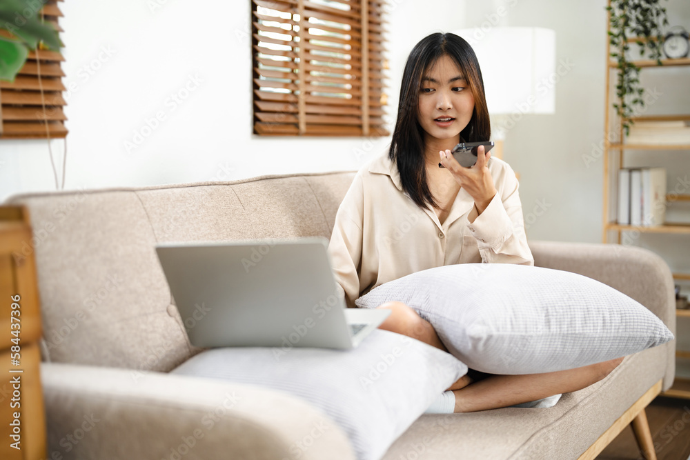 Asian girl using cell phone for checking social media at home holding smartphone in morning. Asian girl using cell phone for checking social media at home holding smartphone in morning.